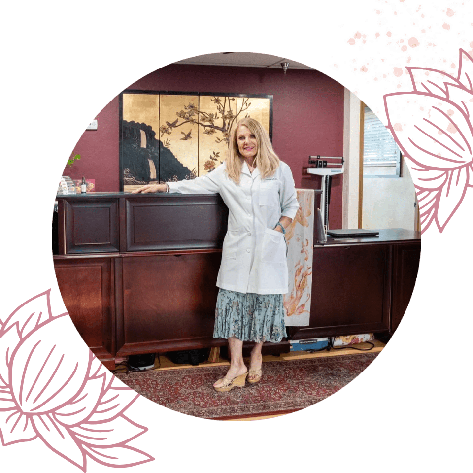 A woman standing in front of a counter.